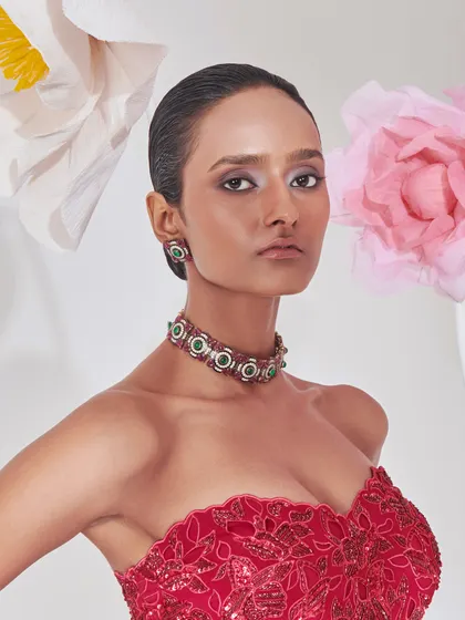 A close-up of the red gown's bodice, showing the intricate embroidery and the modern jewellery I selected to complement it.