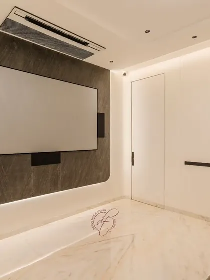 A view of the home theater with the screen off, showcasing the sleek design of the accent wall with integrated LED backlighting. The minimalist aesthetic ensures the focus is on the cinematic experience.