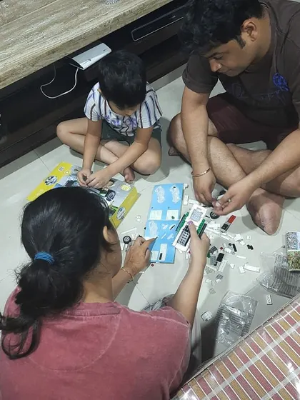 A family bonding moment over a Lego project. Building together is a fantastic way to develop fine motor skills, learn to follow instructions, and practice teamwork.