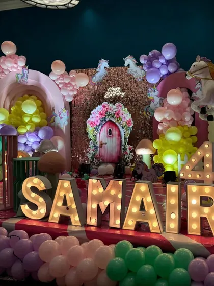 The full name and age in marquee letters for the enchanted garden party, creating a perfect photo opportunity.