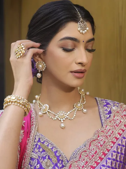 This shot highlights the beautiful pearl and diamond jewellery, which is complemented by the understated makeup.