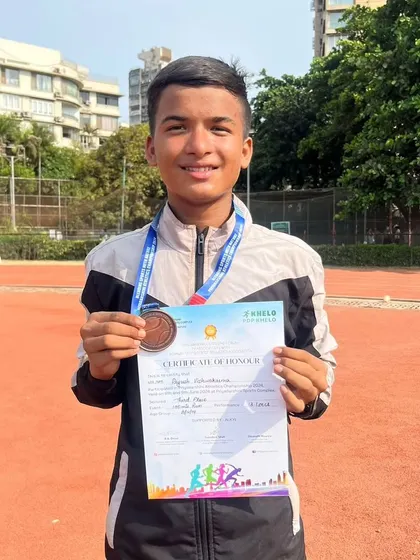 A proud Piyush holding his certificate of honor from the PDP Athletic Competition.