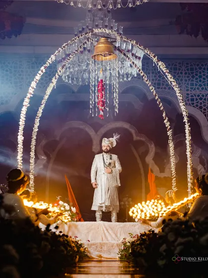 The groom's grand, solitary entrance under a beautifully decorated arch, ready for his royal wedding.
