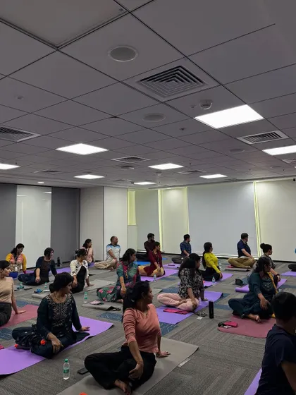 A moment of shared practice inside the Manhattan Associates office. Even in a corporate meeting room, we can create a sanctuary for mindfulness and movement.