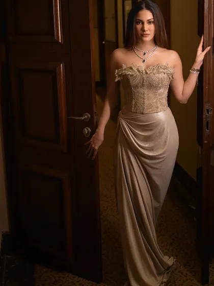 Amyra Dastur standing in a doorway, looking towards the camera. This classic pose is timeless and elegant.