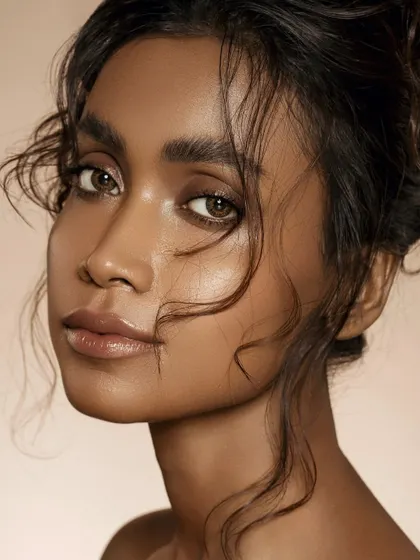 A portrait that celebrates natural, breathing skin. The soft, undone hair and minimal makeup direct all attention to the model's healthy, hydrated complexion and luminous highlights, a signature of our skin-first approach.