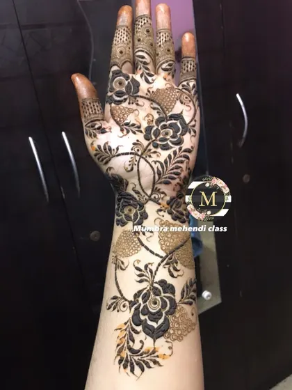 A full-arm floral design with delicate, shaded leaves.
