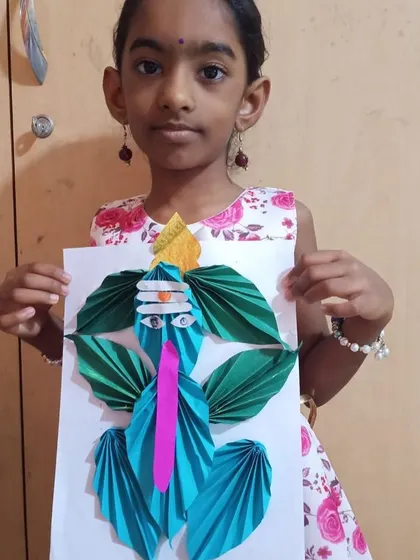 Each child's Ganesha artwork is unique. This student used different colored paper to create her own beautiful version of the deity, showcasing her personal artistic choices.