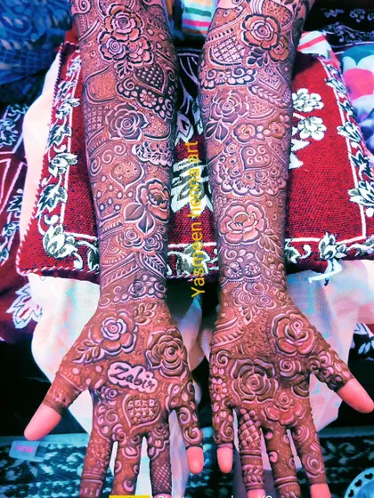 Bridal mehndi with the groom's name, Zabir, on the palm. The design is a beautiful mix of modern and traditional styles.
