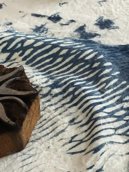 Explore the timeless art of block printing with our extensive collection of hand-carved wooden blocks. This image captures the beautiful texture of indigo dye on fabric, a perfect example of the rich, organic patterns you can create here.