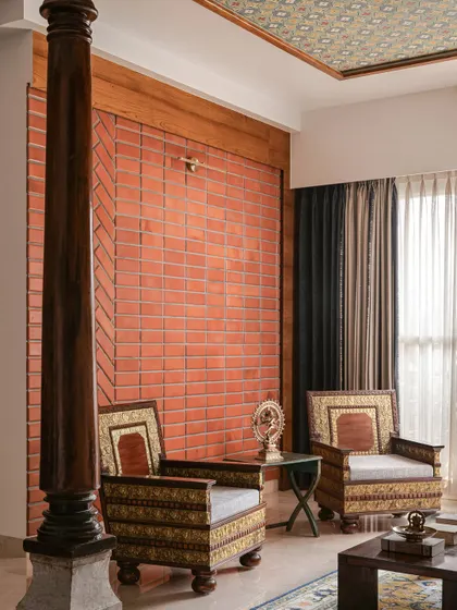 Another angle of the living room, highlighting the contrast between the rough texture of the exposed brick and the smooth, polished marble floor.