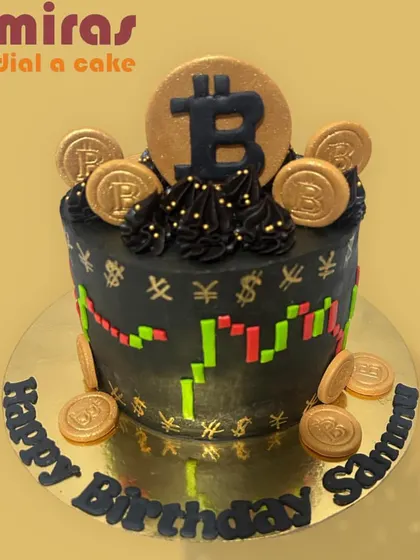 This Bitcoin cake is pure gold for a crypto trader. The black cake is decorated with an edible stock chart and topped with golden Bitcoin coins, making it a rich and trendy birthday theme.