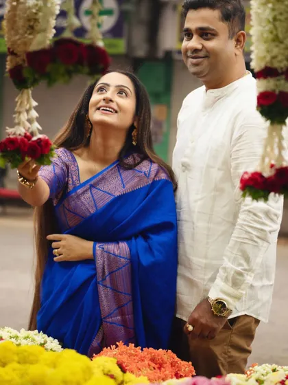 A candid moment at the vibrant flower market. The couple's shared glance amidst the colorful blooms tells a story of love and simple joys.