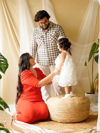 A beautiful interaction as this little girl stands on the pouf to connect with her parents. Our studio setups are designed to encourage natural family moments.