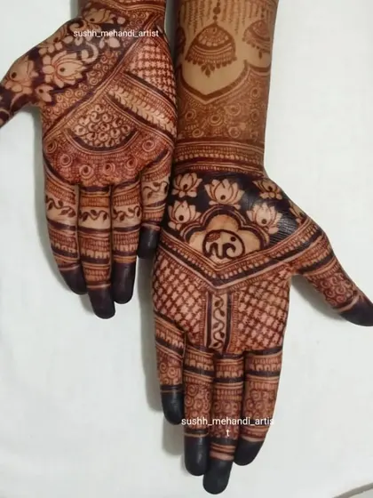 A lovely design combining lotus flowers, elephants, and jhumkas. The fingertips are fully covered for that deep, dark stain.