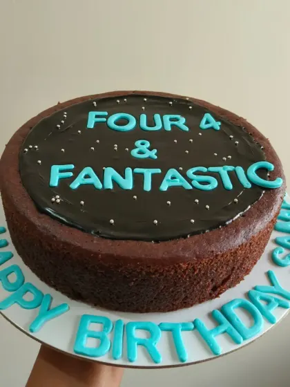 A simple chocolate cake for a "Four & Fantastic" 4th birthday, with a glossy chocolate ganache topping.