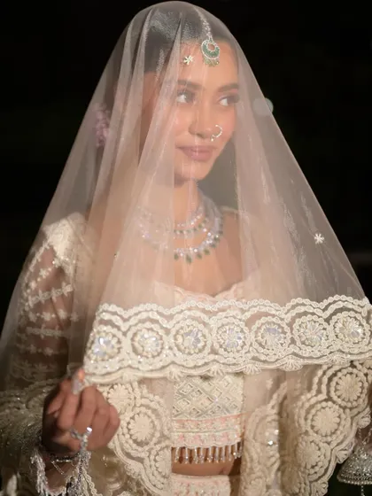 A beautiful portrait of the bride under her veil. The look is ethereal, graceful, and utterly captivating.