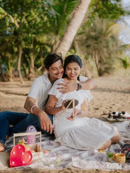 A candid moment during a picnic-themed pre-wedding shoot on the beach.