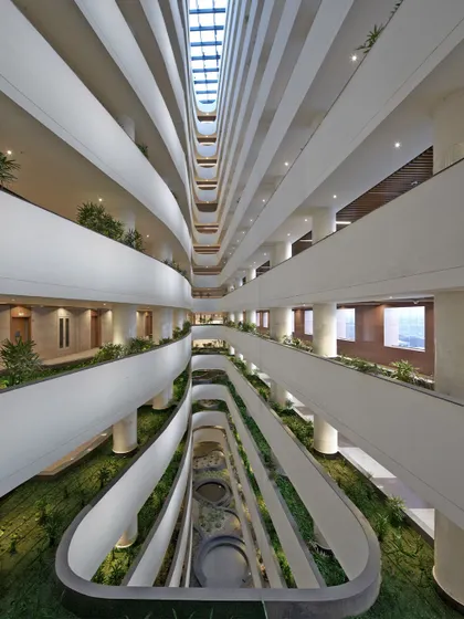 The design for the Surat Diamond Bourse, the world's largest office building, features a series of staggered atria that act as green lungs for the structure. These vertical voids are filled with planting and allow hot air to escape, fostering a comfortable microclimate without mechanical cooling.
