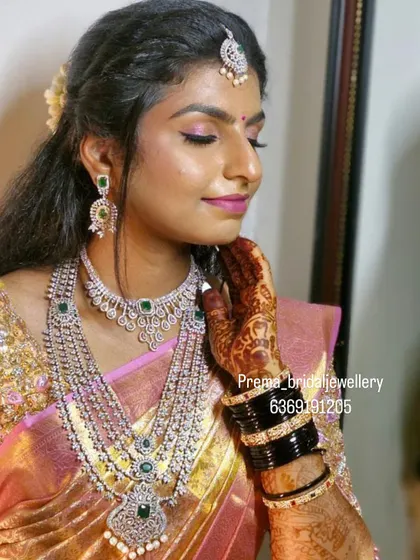 A close-up portrait of the bride, highlighting her makeup and the sparkling AD jewellery.