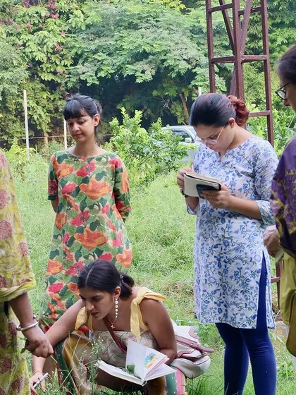 Participants of our Wild Food Walk gather to learn from expert forager Shruti Tharayil. They are identifying edible plants growing right here on the farm.