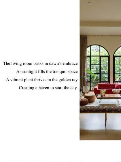 The living room at Casa 503, where large arched windows flood the space with morning light. The vibrant furniture and lush plants create a tranquil haven to start the day.