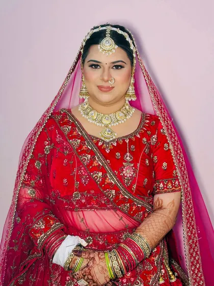 A smiling bride ready for her big day. The focus was on creating a radiant, glowing base that looks like second skin, a popular request from modern brides.