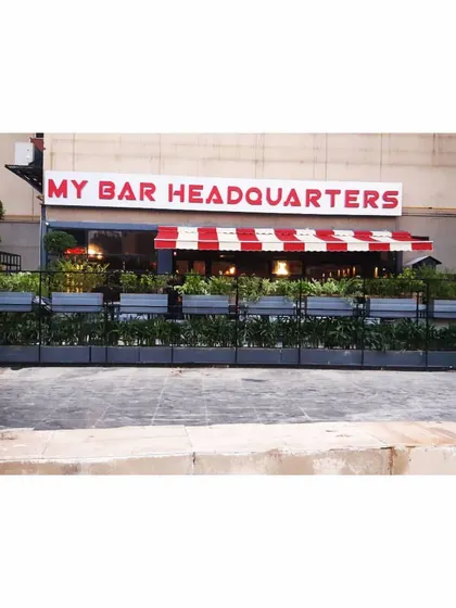 A frontal view of the planter wall at My Bar Headquarters. This functional landscaping solution defines the restaurant's outdoor space while adding significant curb appeal and a fresh, green look to the building's facade.