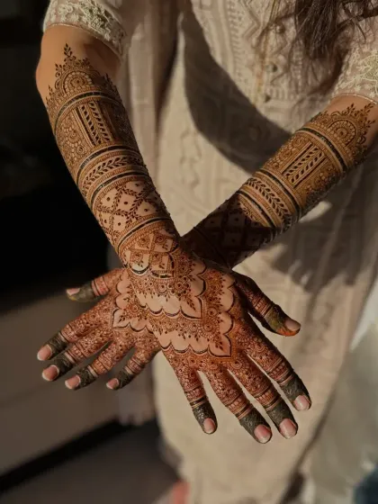 Another angle of the same stunning bridal design, showcasing the intricate patterns on the arms.