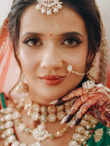 An extreme close-up of a Gujarati bride, focusing on the sharp winged liner, traditional bindi, and the flawless skin finish.