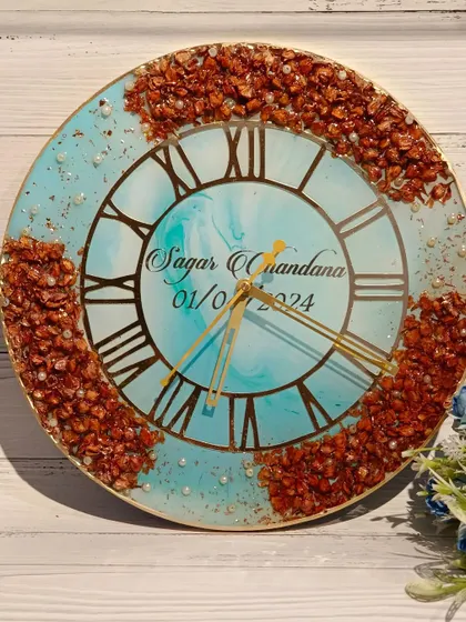 This clock features a beautiful turquoise marble-effect background with a border of preserved flowers. The contrast of the earthy flowers and the bright blue is stunning.