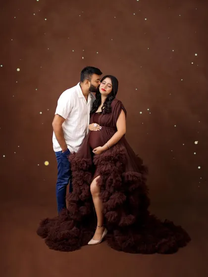 An intimate couple's portrait in our studio. The rich brown ruffled gown and sparkling lights create a warm, romantic, and slightly magical atmosphere.