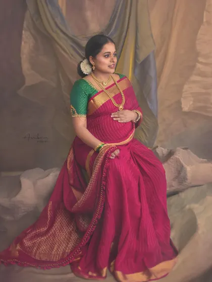 Inspired by the artistic periods of Picasso, this portrait plays with texture and form. The mother-to-be in her pink saree is set against a draped, painted backdrop, creating a unique, abstract, and artistic composition.