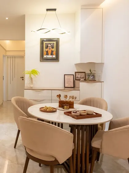 A closer look at the elegant dining area, showing the sleek, modern crockery unit that provides ample storage while maintaining a minimalist look.