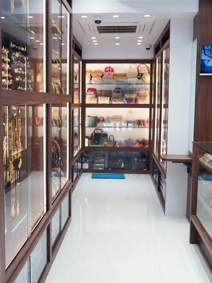 A sneak peek into the clean and well-organized aisle of my new store, with jewellery displayed in brightly lit glass cabinets.