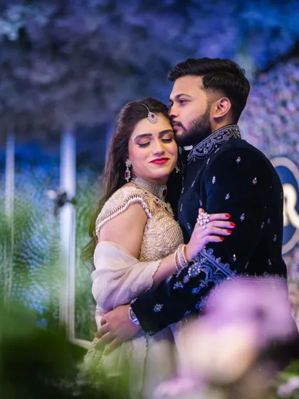 An intimate embrace captured at the engagement. Mahima's makeup is perfectly applied, with a bold red lip that adds a touch of romance and drama.