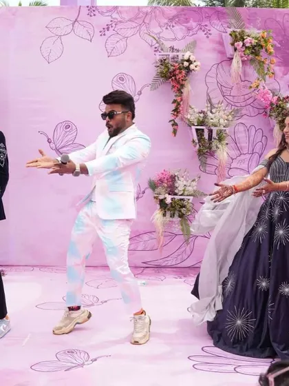 Twisting through life's adventures. A fun dance moment at a pastel-themed carnival party, with a beautiful floral and butterfly backdrop.