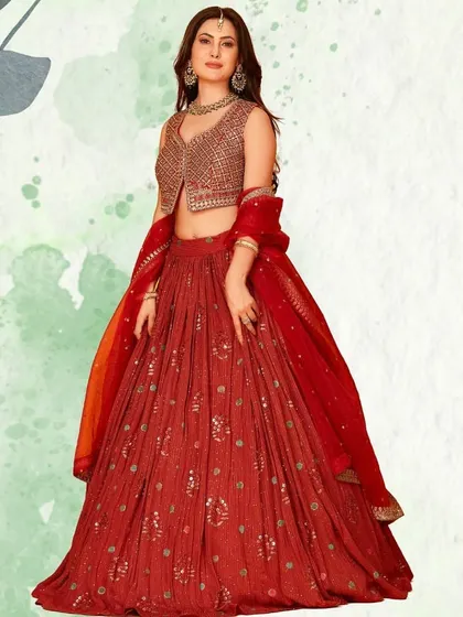 A beautiful red lehenga with a modern twist, featuring a stylish embroidered jacket-style blouse. This piece is perfect for a pre-wedding function or for the contemporary bride.
