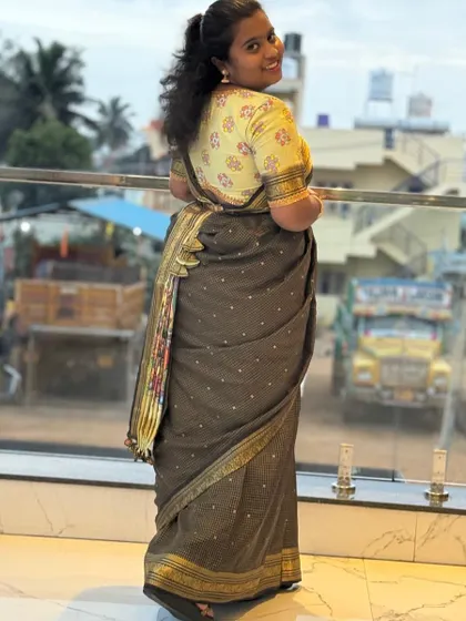 A back view of Varsha's saree, showing the beautiful fall of the fabric and the custom-designed blouse.