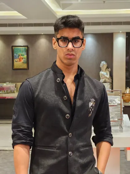 A simple yet stylish black waistcoat worn over a black shirt. This is a versatile look that works for parties or formal dinners.