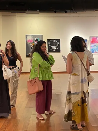 Visitors at my art exhibition, viewing my collection of original works. It is an honor to have my art curated and to engage with people who connect with my vision.