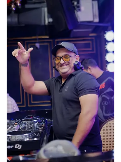 A candid shot from behind the decks during a busy night. I'm always smiling when the music is good and the crowd is having a great time.