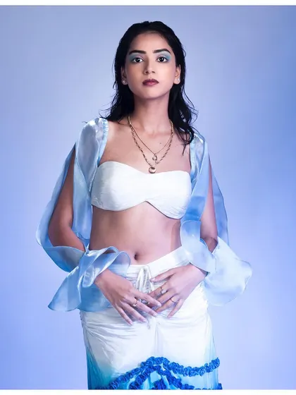 Inspired by water, this portrait uses a cool blue gel light to set the mood. The model's wet-look hair and the sheer, flowing fabric enhance the aquatic theme.
