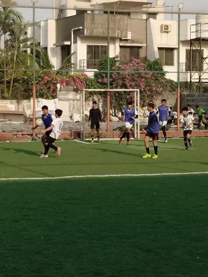 A wide shot of a match in progress, with players spread across the field. This demonstrates a real game scenario where players must apply their knowledge of team tactics and positioning.