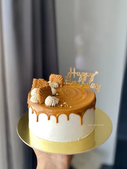 A beautiful Vanilla Biscoff cake with a caramel drip, topped with Biscoff cookies. It's one of my most requested flavor combinations.
