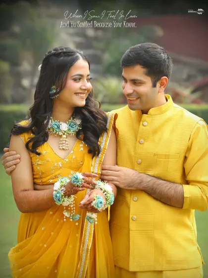 "When I saw you, I fell in love. And you smiled because you knew." A romantic close-up of the couple at their Haldi, adorned with beautiful floral jewelry.