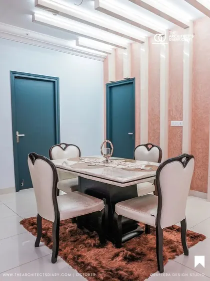 This dining space combines elegance and modernity. I used a classic four-seater dining table and paired it with a textured, striped pink wallpaper and contemporary ceiling lights to create a warm and inviting atmosphere.