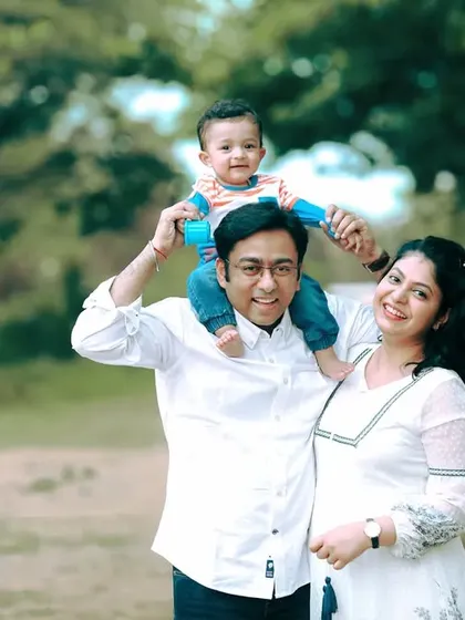 This is what it's all about. A happy family portrait taken outdoors in Bangalore, with everyone relaxed and smiling. I love capturing these natural moments of connection, like this little one enjoying a ride on dad's shoulders.