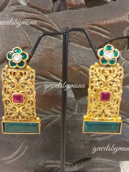From my Dakshinaya collection, these earrings feature intricate gold filigree work, a floral top, and are accented with ruby and emerald-colored stones. They capture the essence of traditional temple jewellery.