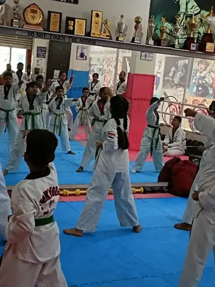 A wide shot of the class practicing, showing the energy in the room.